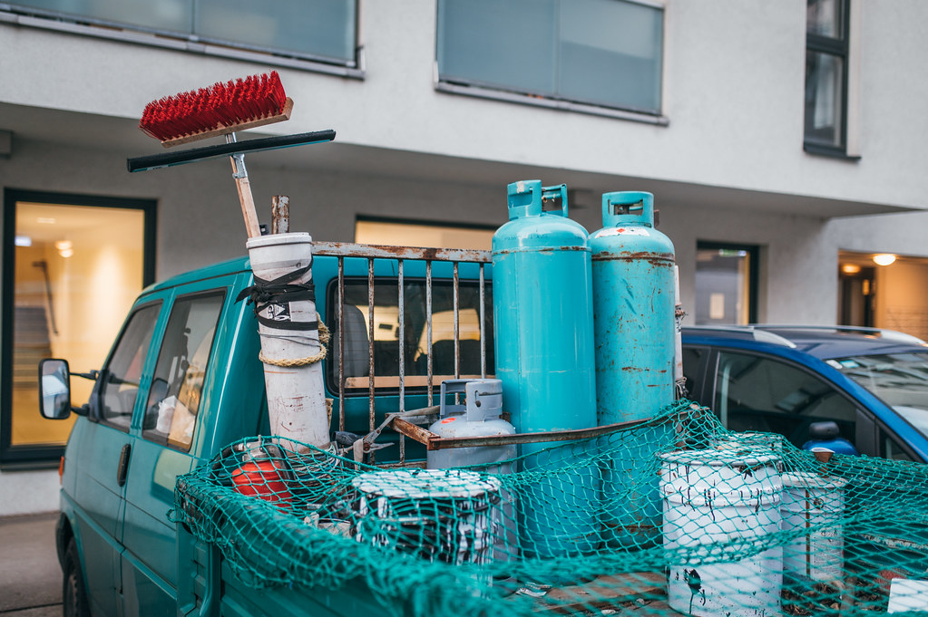 Truck trailer with gas canisters and cleaning supplies covered with safety net